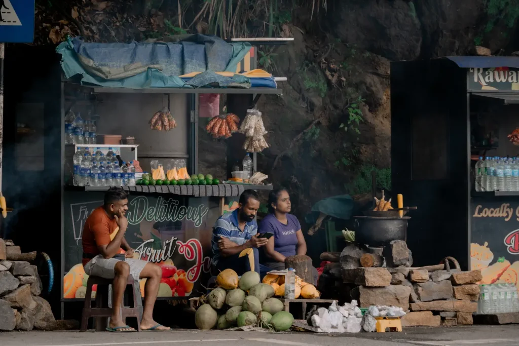 a roadside stall selling fruit and coconuts in sri lanka.