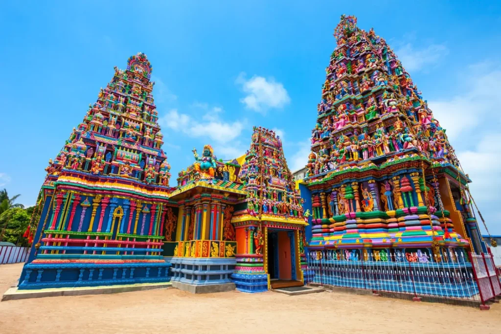 a vibrant, multi-colored hindu temple with intricate statues on its towers.