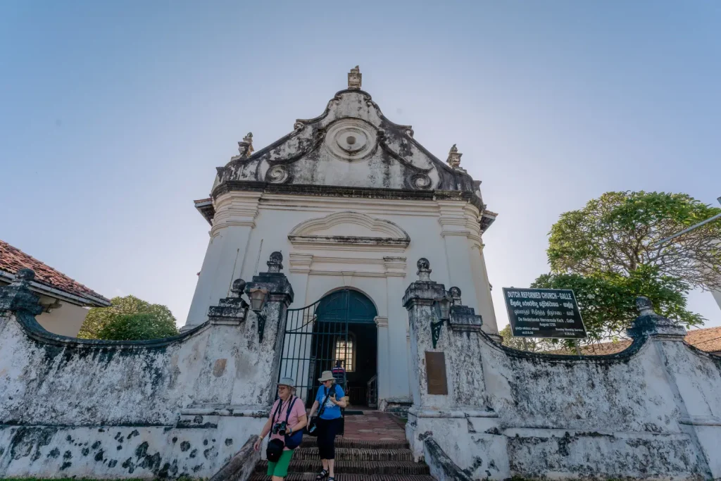 tourists leaving the historic dutch reformed church in galle, sri lanka.